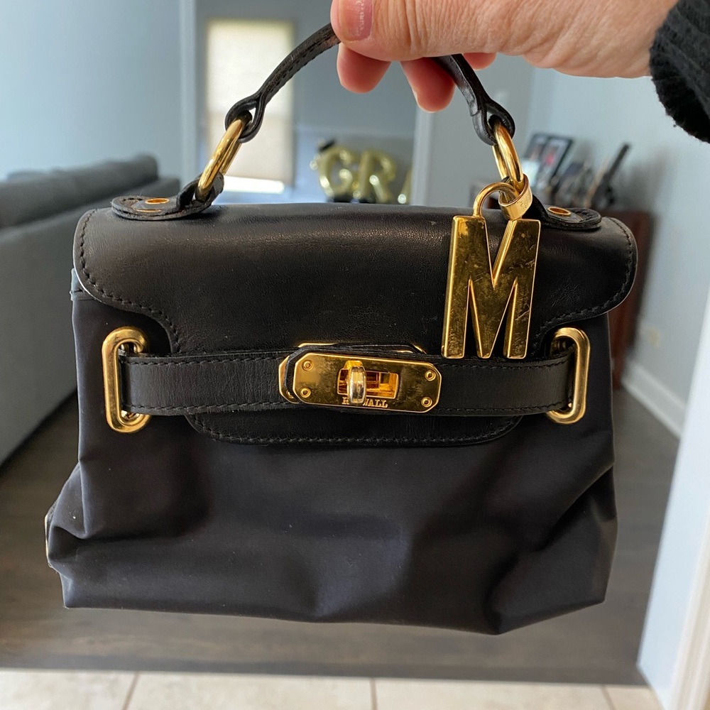 Moschino Mini black nylon and leather purse with gold trim.